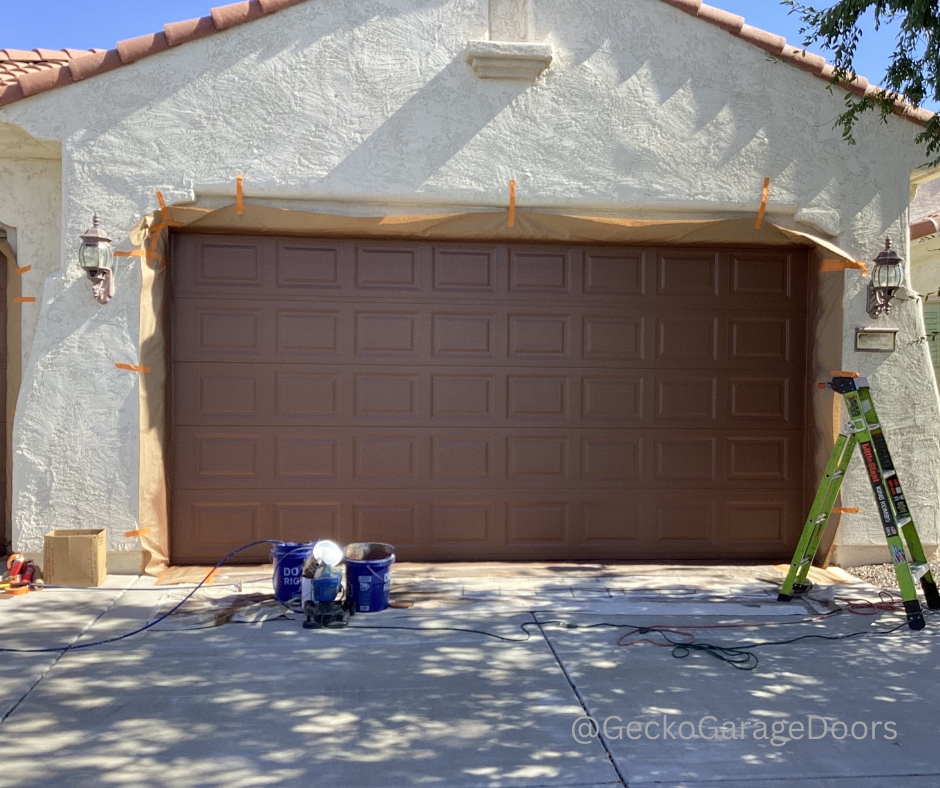 Example of a newly installed 3 car garage door being painted by our technicians.